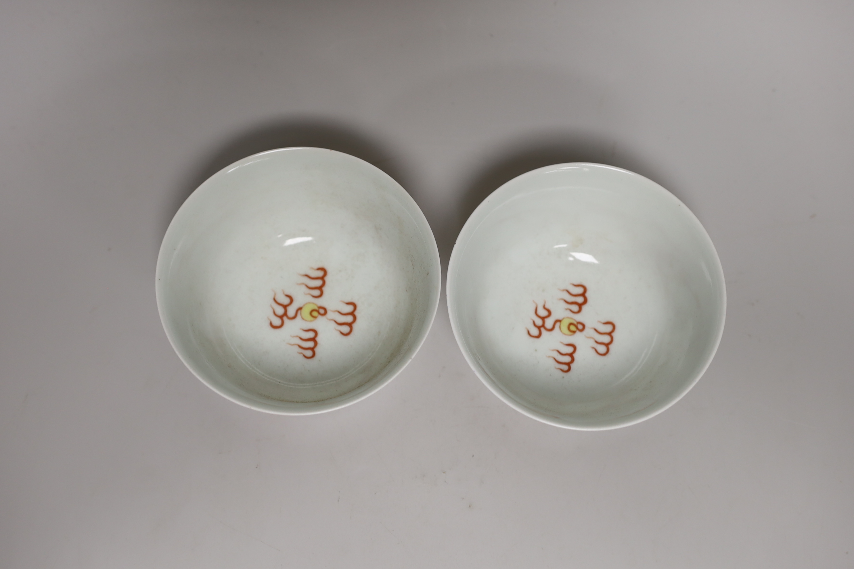 A pair of Chinese iron-red decorated ‘dragon’ bowls (bowed) bowls 6.5cm high